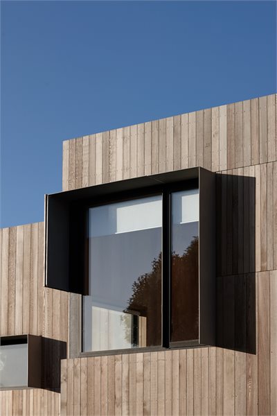 Protruding sunshades surround the black anodised joinery