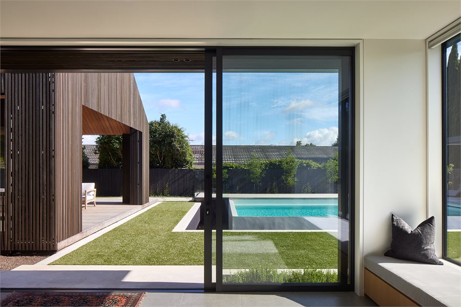 Sliding doors transition between the kids lounge and the pool