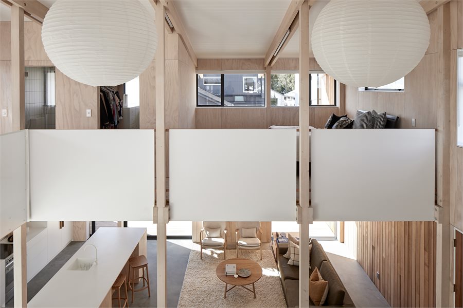 In keeping with the completely open-plan design, John and Nikki's bedroom is separated from the ground floor by half-wall panels.