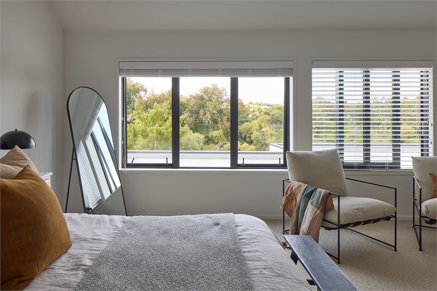 A combination of awning and sliding windows are used in the top level bedroom