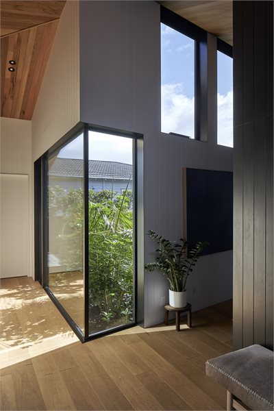 Metro Series picture windows in the hallway let the outside in and turn the courtyard into a sort of terranium.
