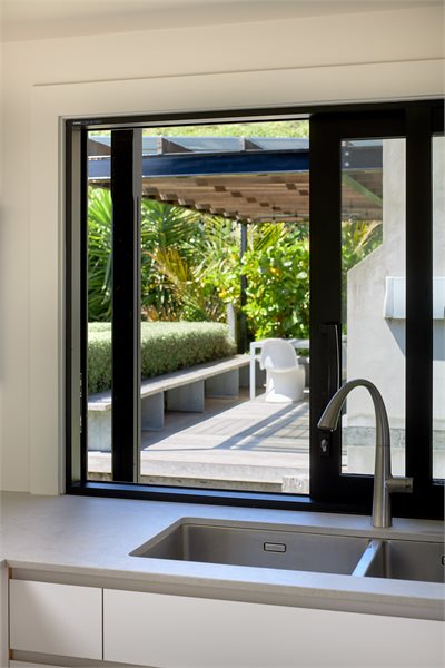 A kitchen sliding window allows for easy food transfer to outdoor living