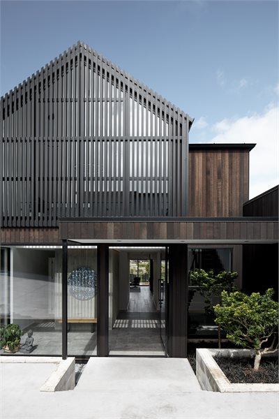 Floor-to-ceiling windows at the front of the house add so much more light into the home