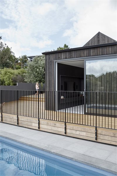 An over-the-wall sliding door provides easy access from the living area to the pool