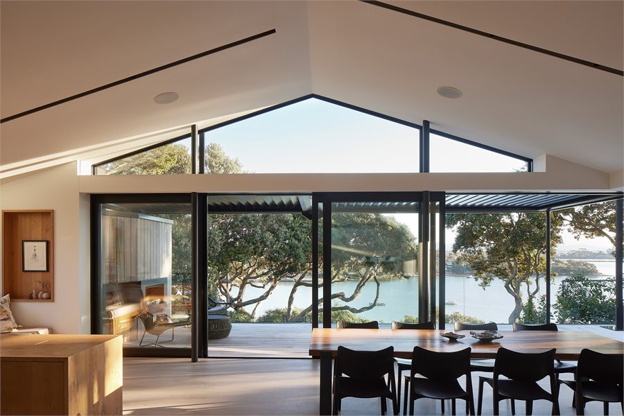 Modern living room with harbour views seen through APL Architectural Series Sliding Doors