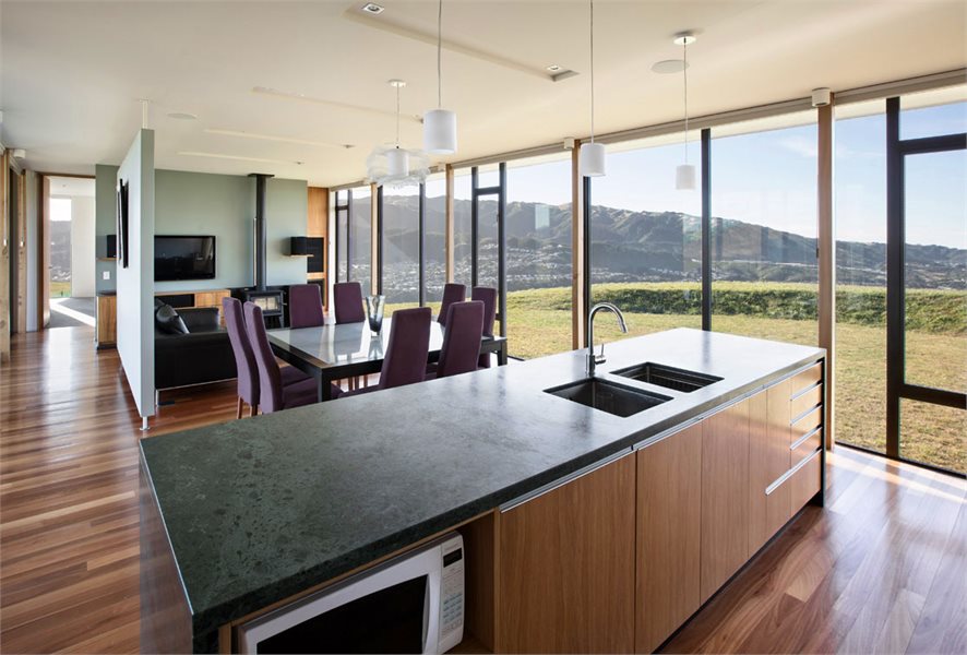 Light-filled kitchen featuring natural materials complimented by APL Architectural Series awning & casement windows