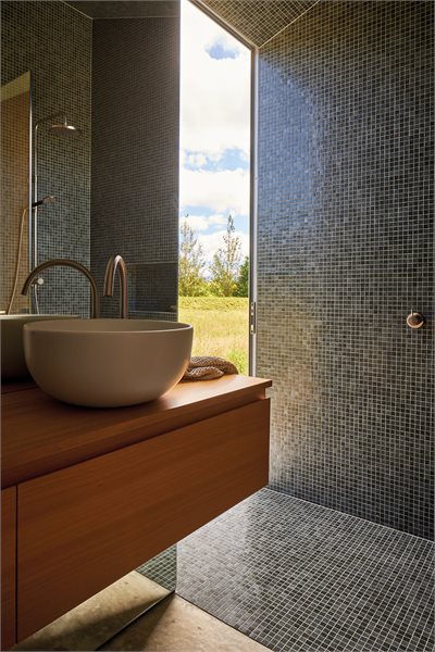 Over the wall sliding doors open up to the rural landscape