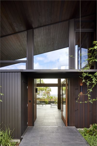 The front entrance is heightened with custom windows to match the angled roof